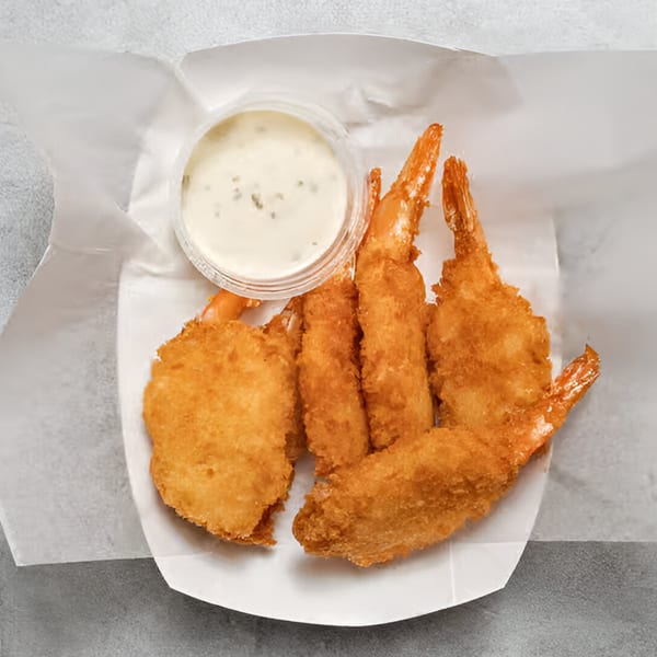 Chicken Holiday's fried shrimp and fish fillet with tartar sauce in a white paper tray.